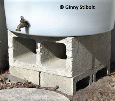 Ginny's stand-alone rain barrel was sinking into the sand because of red imported fire ants. 
		Photo by Stibolt