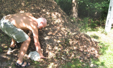 Clearing the chips away from the cover placed over the post sleeve while the chips were being dumped.  Photo by Stibolt