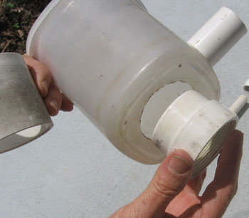The through pipe is a coupling that is connected at the bottom of the catch basin.  Photo by Stibolt.