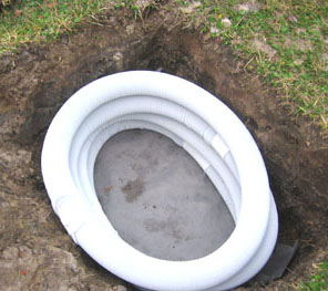 Four ten-foot drainage pipes covered with cloth line the hole. Photo by Stibolt.