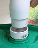 The catchment pipes flow into the top of the barrel through a built-in 2" threaded opening. Photo by Stibolt.