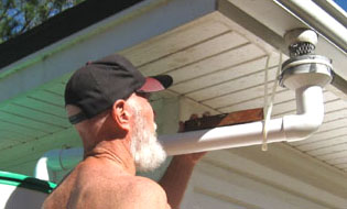 Checking with a level to ensure a slight doward flow to the barrel.  Photo by Stibolt.