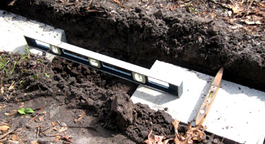 Leveling all ways between the footing blocks.  Photo by Stibolt
